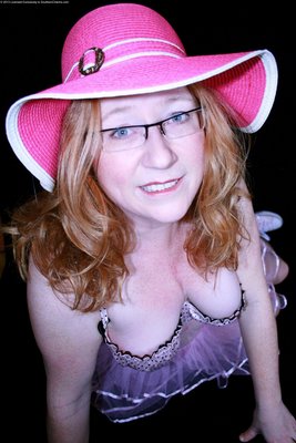 A vivid pink hat and, lovely smile and a frilly bra.